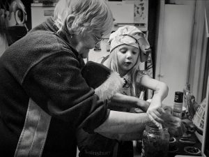 Children making mince pies with grandmother