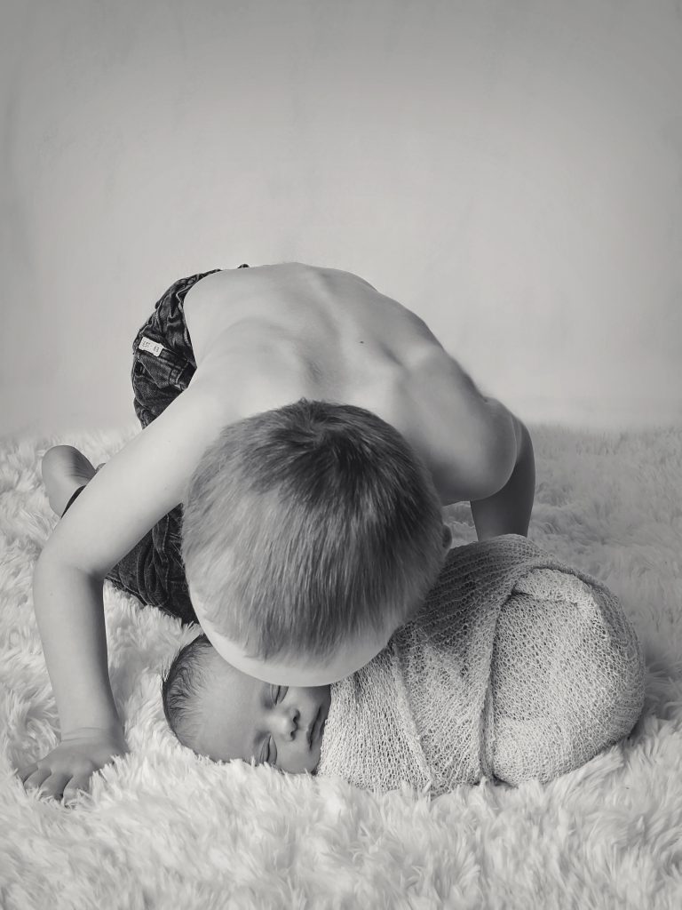 Newborn photography Dover child kissing baby