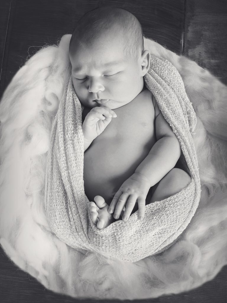 Baby in a basket black and white