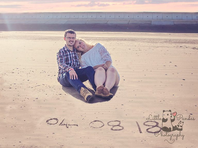 Engagement couple with wedding date in sand
