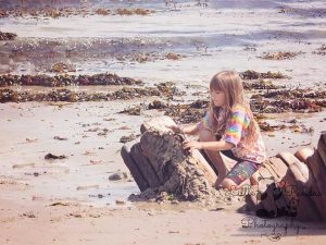 Little girl building sandcastle