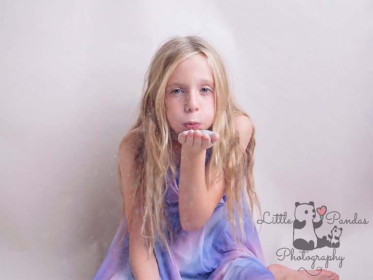 Girl blowing glitter