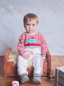 close up little boy in christmas outfit