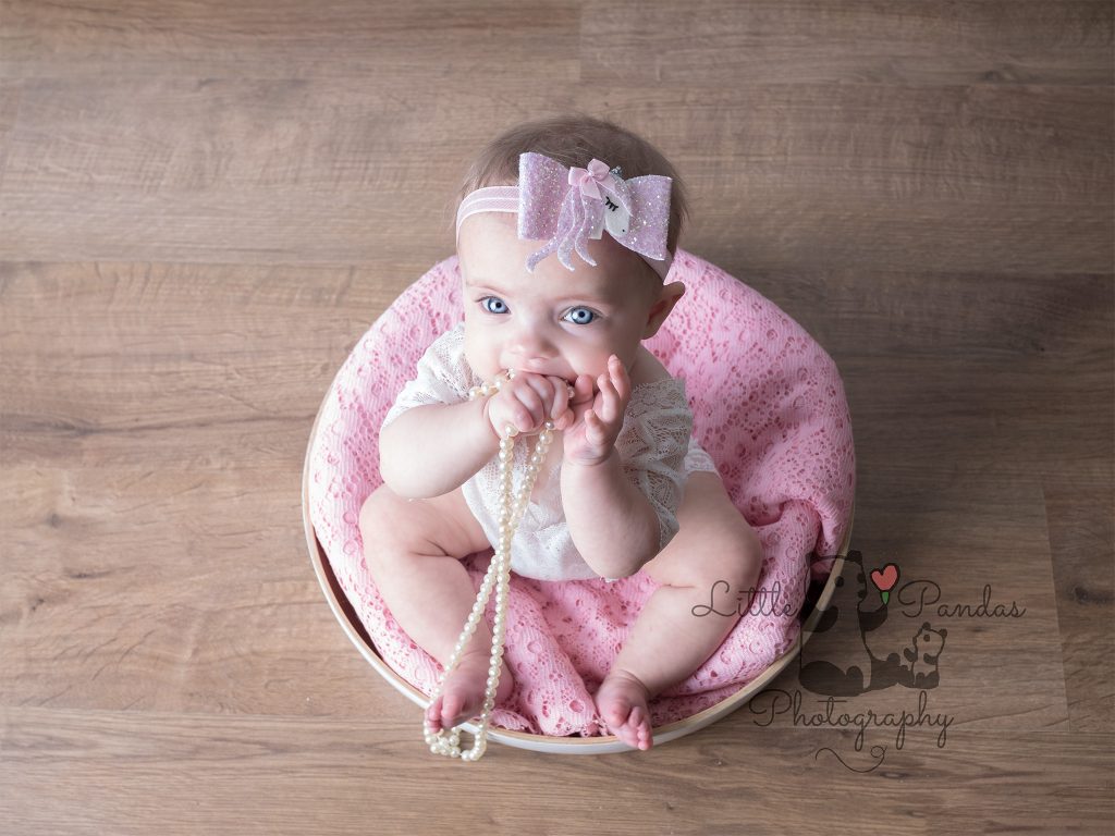 baby girl sitting in basket