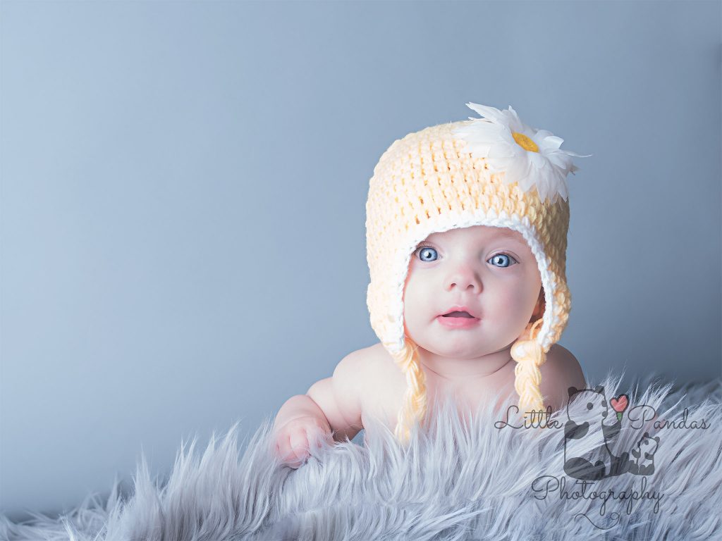 baby girl in yellow hat