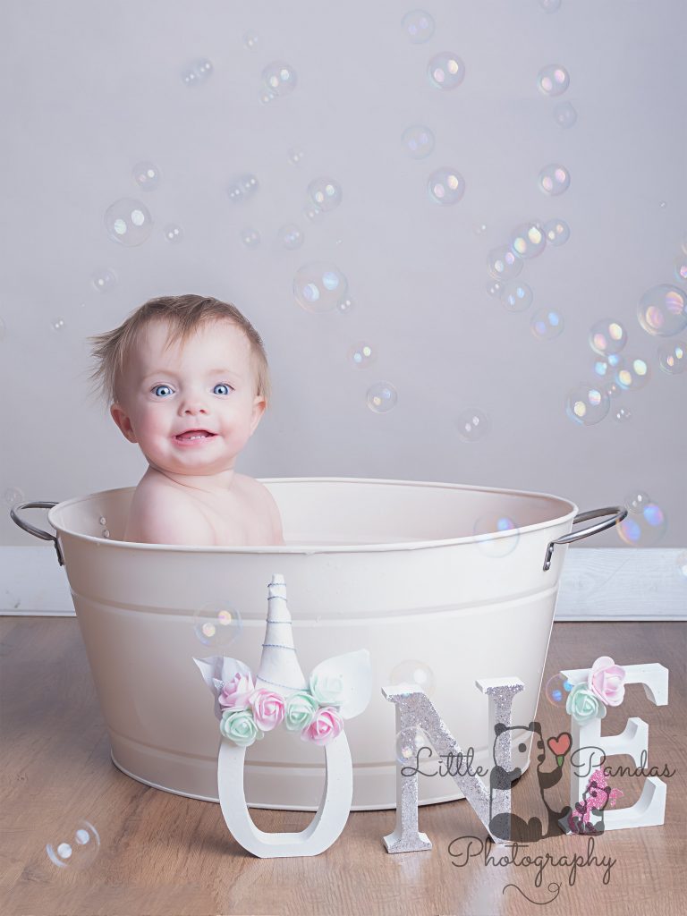 Little girl smiling in tin bath