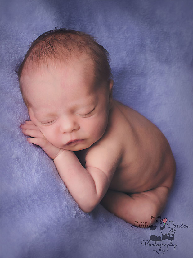Baby girl asleep on purple newborn photography