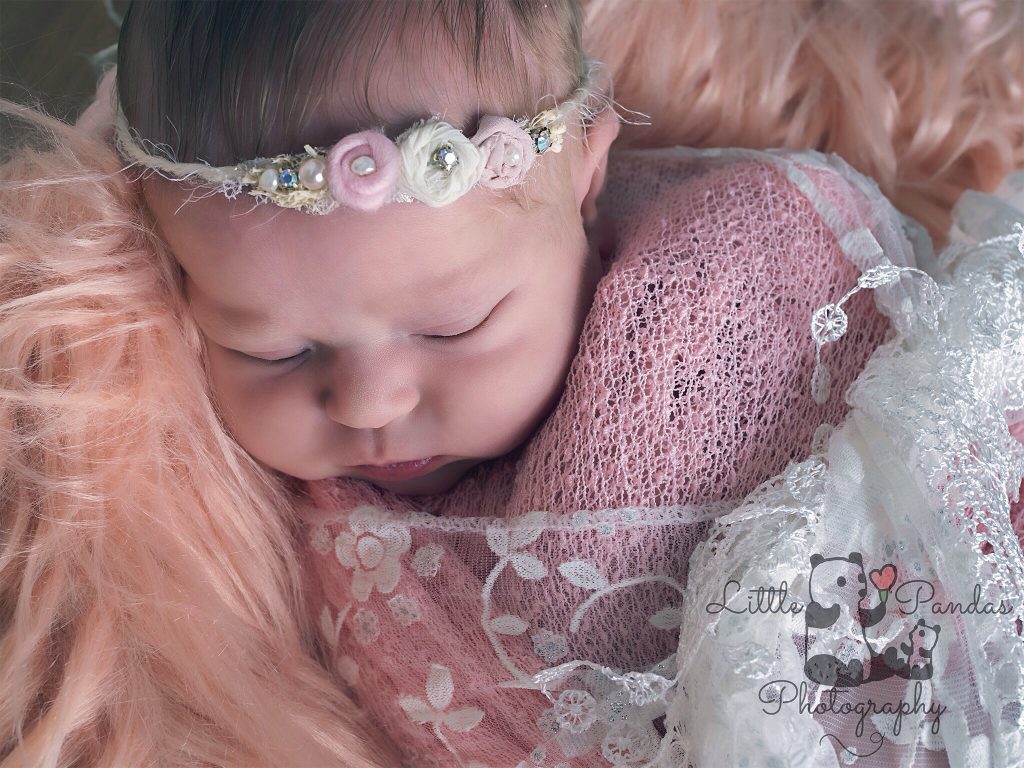 Newborn baby girl close up pink headband