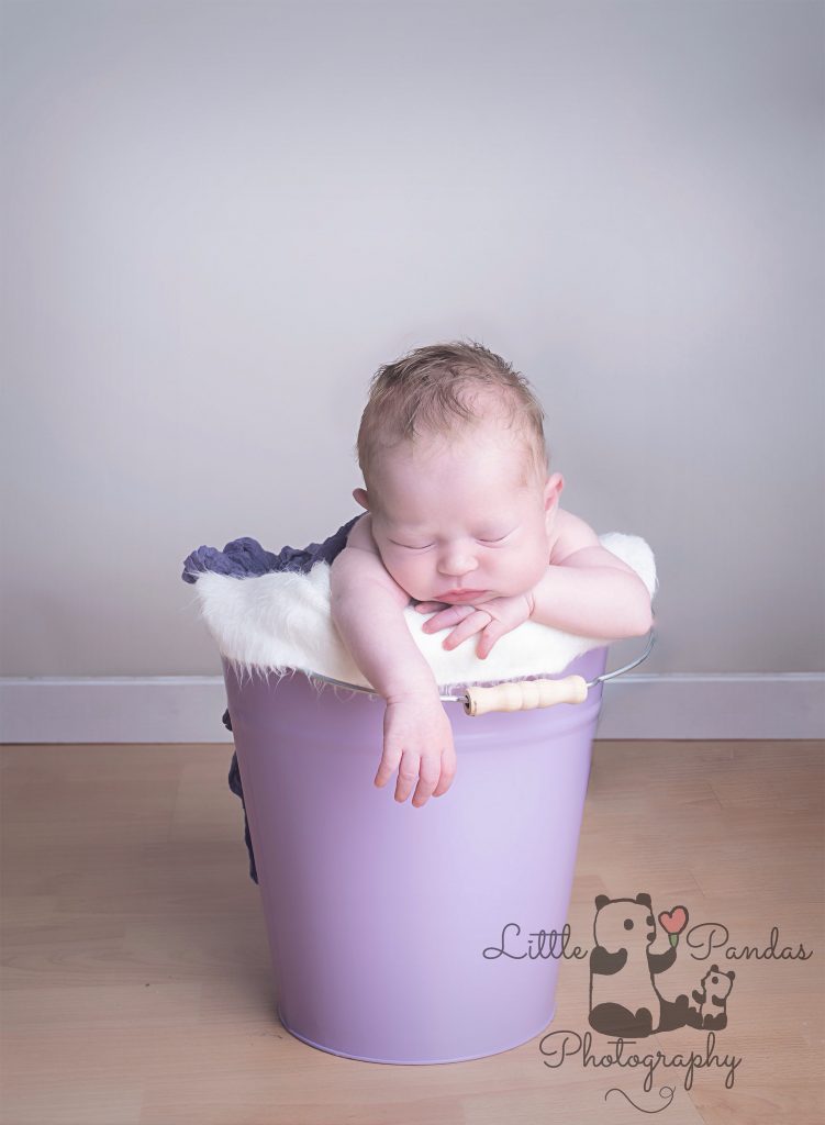 Baby girl in bucket purple
